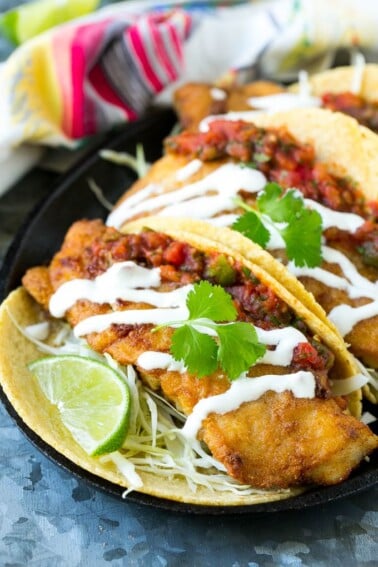This recipe for Baja fish tacos is crispy fish fillets with cabbage, salsa and creamy sauce, all wrapped in warm corn tortillas. Just like you'd get in a restaurant, except better!