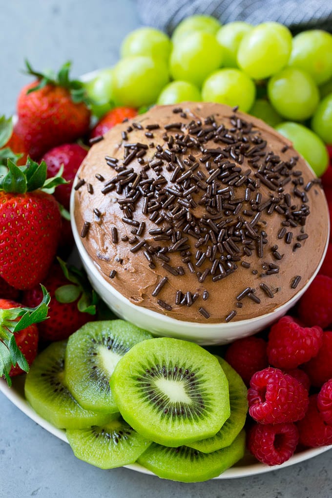 A bowl of chocolate fruit dip topped with sprinkles.