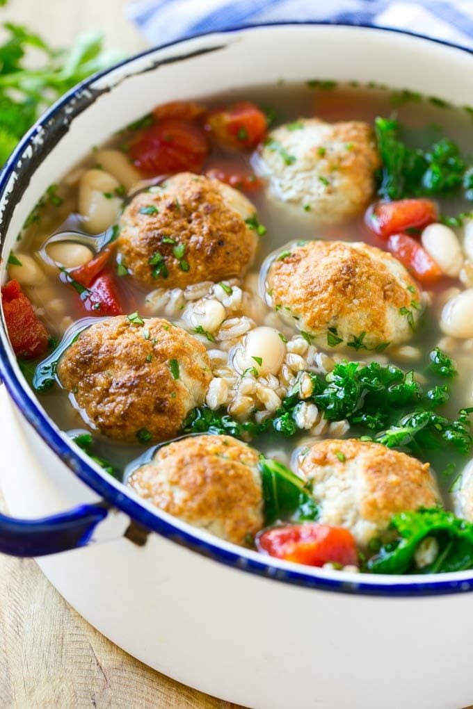 A pot of farro soup with meatballs, white beans and kale.