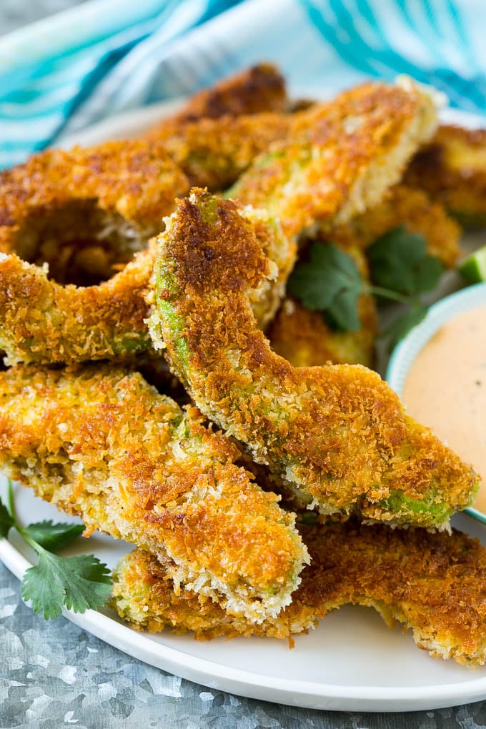 A plate of avocado fries garnished with fresh cilantro.