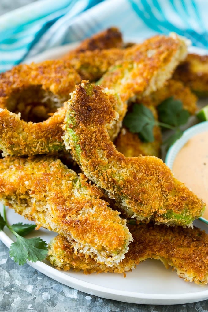 Avocado Fries Recipe | Fried Avocado | Avocado Fritters #avocado #appetizer #snack #dinneratthezoo A plate of avocado fries garnished with fresh cilantro.