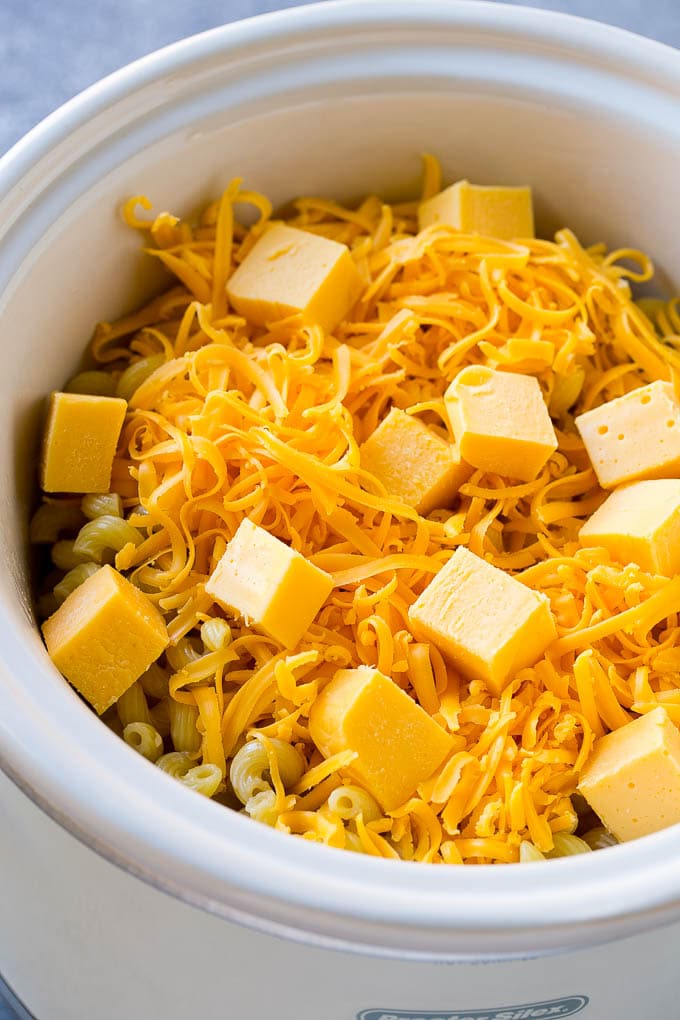 Pasta, cheeses and milk in a crock pot.