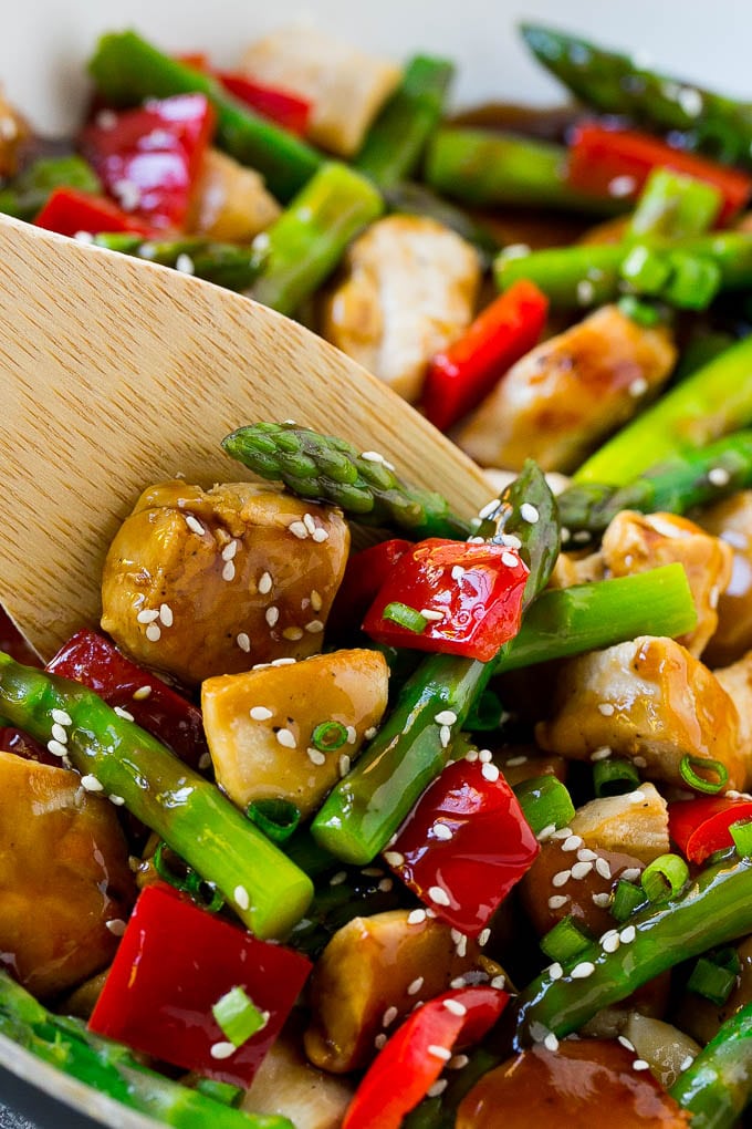 Chicken teriyaki in a pan with a spatula.