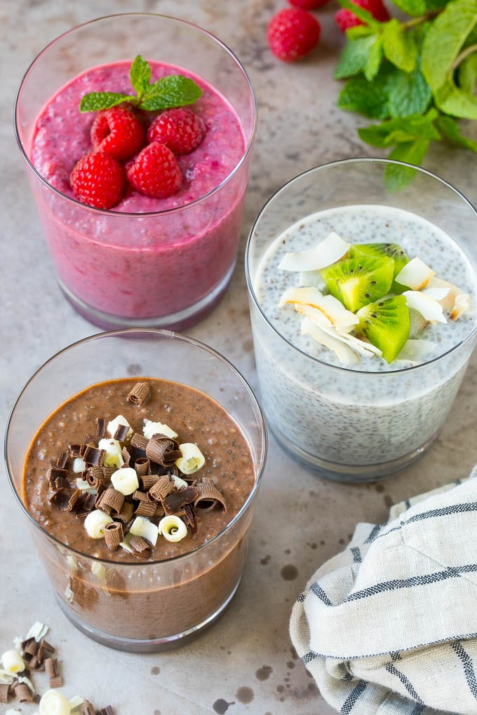 Three types of chia pudding with assorted garnishes.