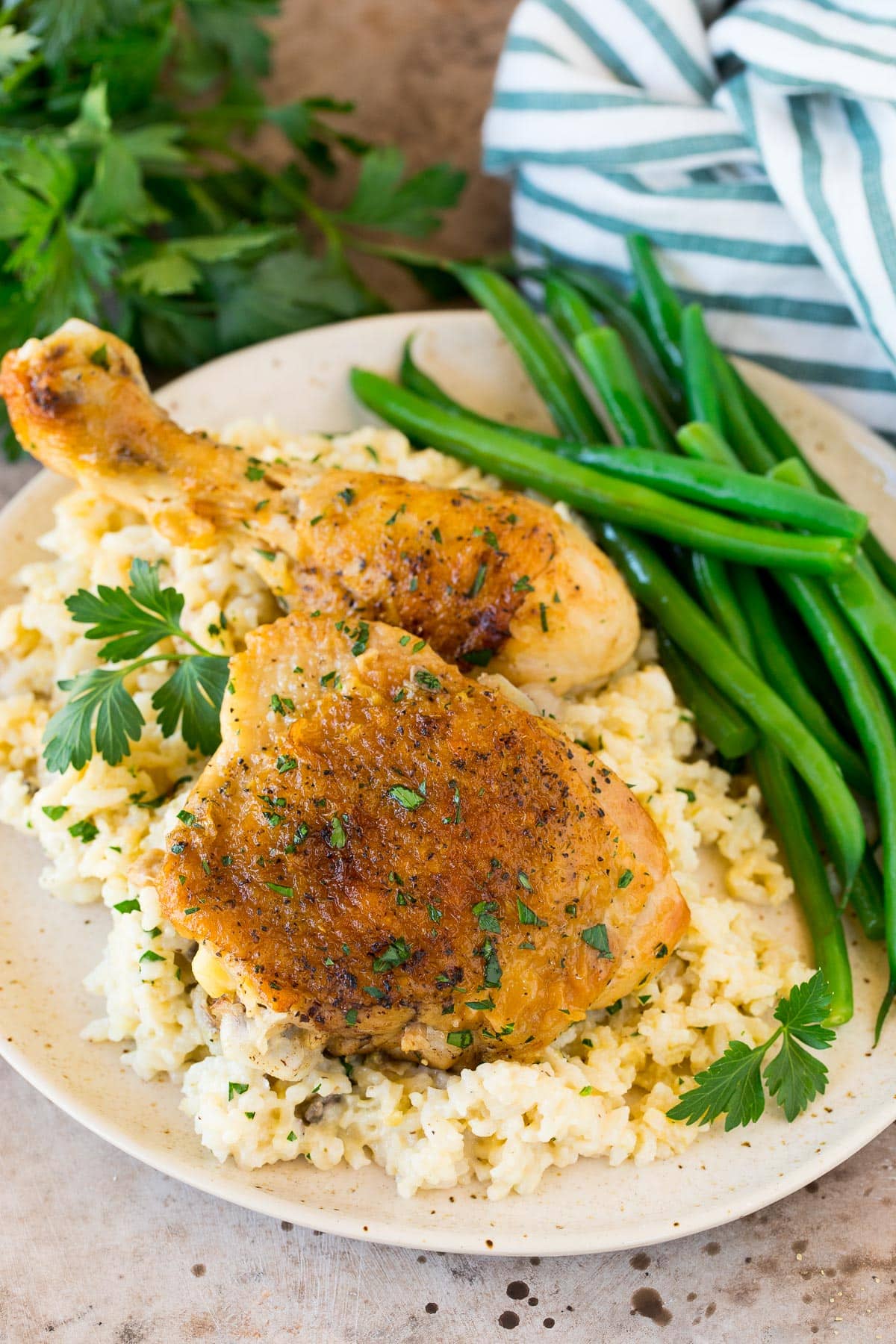 Chicken and rice casserole served on a plate with green beans.