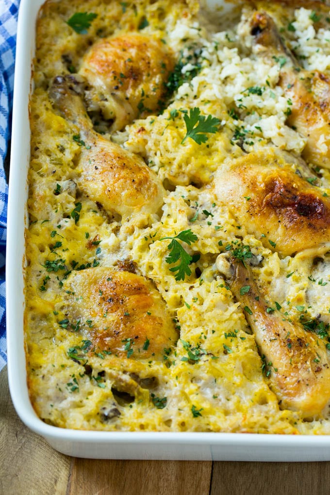 Chicken and rice casserole in a white baking dish, topped with chopped parsley.