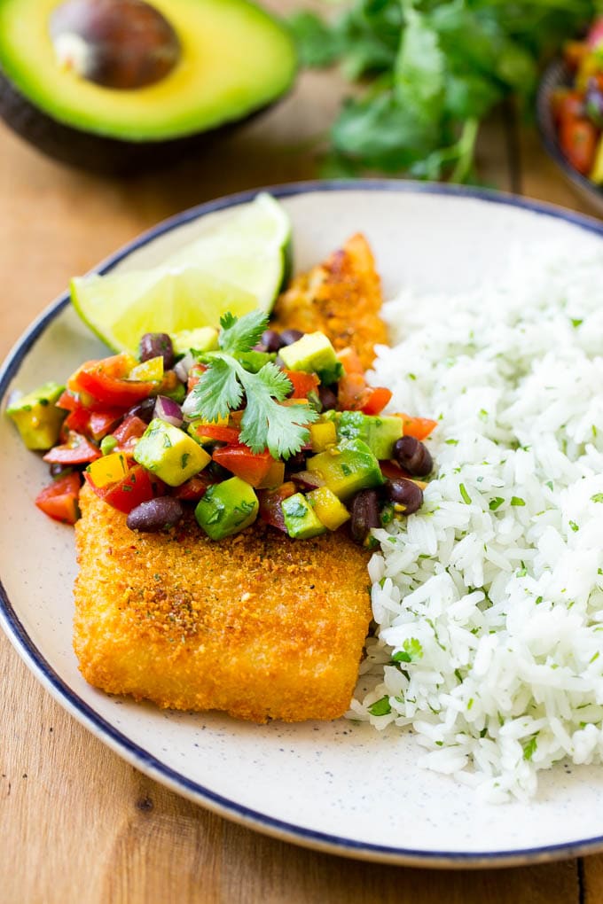 A fajita fish fillet served with cilantro lime rice and avocado salsa.