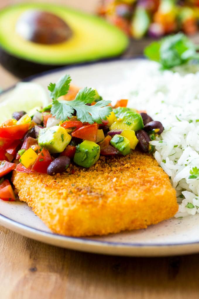 Crispy fish topped with avocado and black bean salsa.