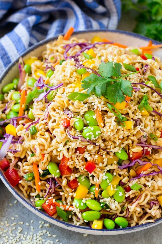 A bowl of Asian noodle salad with colorful vegetables.