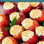 These cheesecake stuffed strawberries are fresh berries that are hollowed out, then filled with sweetened cream cheese and topped with crushed graham crackers.
