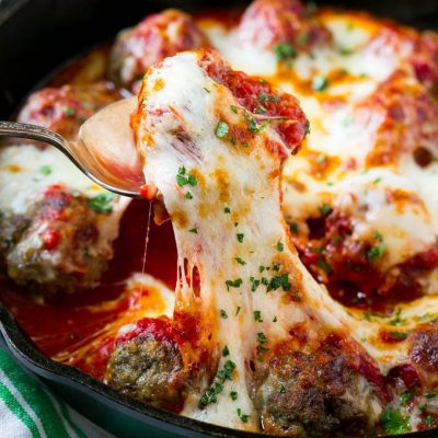 This meatball bake recipe is homemade meatballs, broiled to perfection and smothered in tomato sauce and melted cheese. A quick and easy dinner option that's sure to please the whole family!