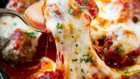 This meatball bake recipe is homemade meatballs, broiled to perfection and smothered in tomato sauce and melted cheese. A quick and easy dinner option that's sure to please the whole family!