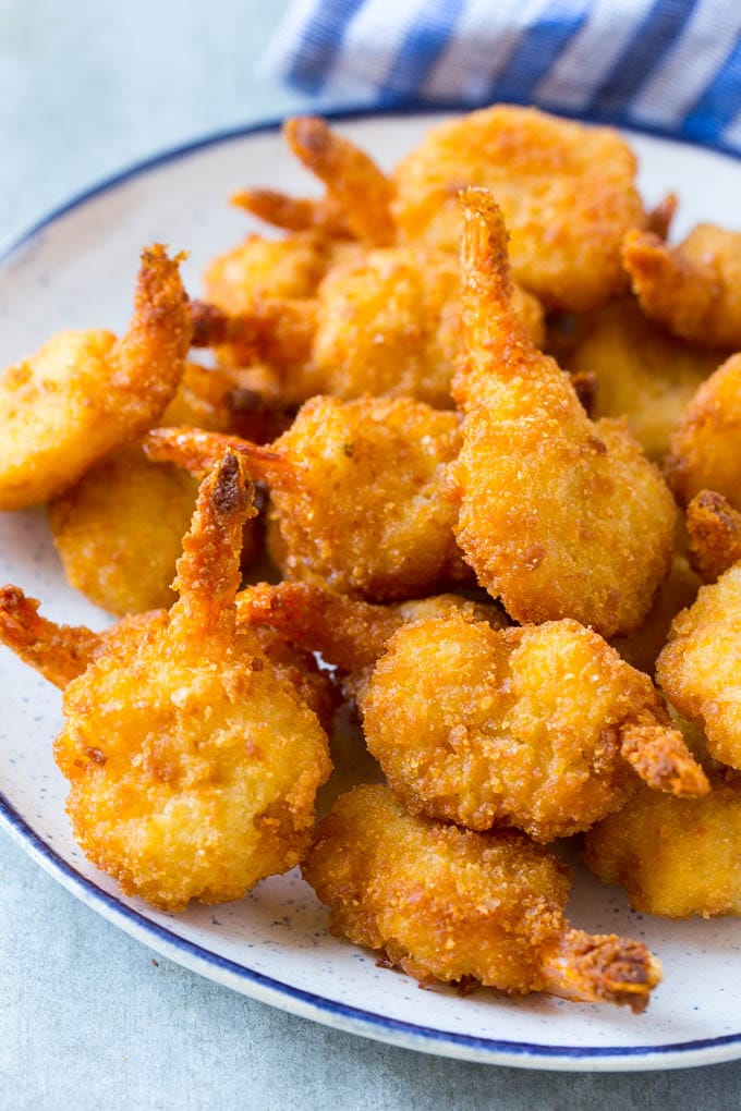 Cooked butterfly shrimp on a serving plate.