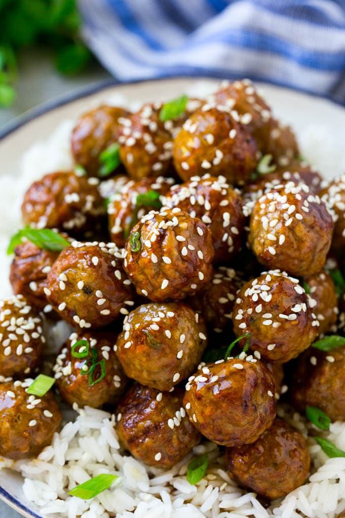 Teriyaki meatballs topped with homemade sauce and sesame seeds.