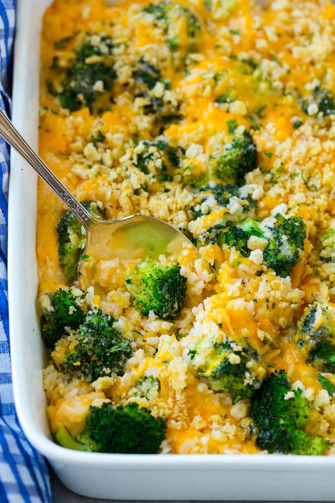 A broccoli and cheese casserole with a spoon coming out of it