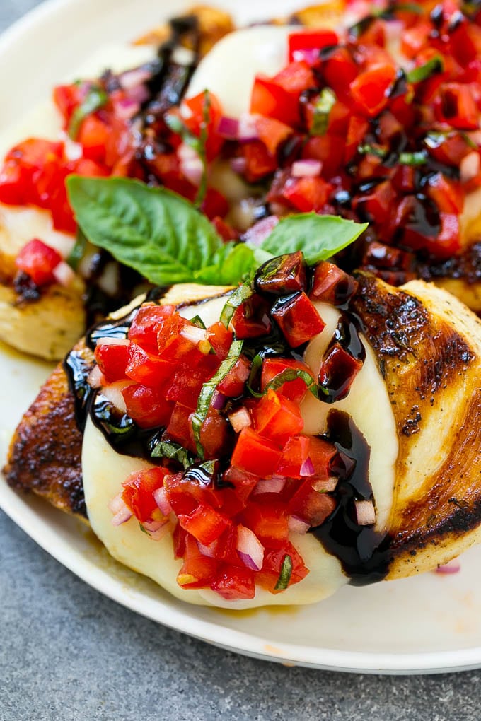 Bruschetta chicken with mozzarella cheese, tomatoes and balsamic glaze.