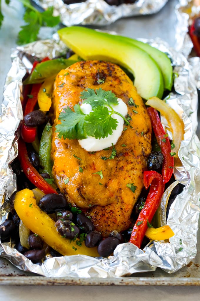 A foil pack chicken breast seasoned with fajita spices and covered in melted cheese.