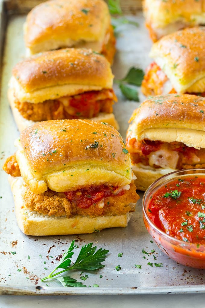 Chicken parmesan sliders made with crispy chicken, marinara sauce and cheese on buns.