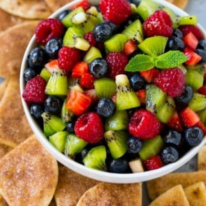 A bowl of fruit salsa served with cinnamon sugar chips.