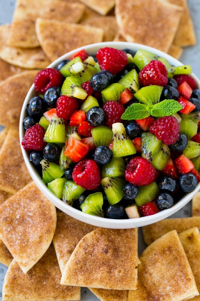 A bowl of fruit salsa served with cinnamon sugar chips.