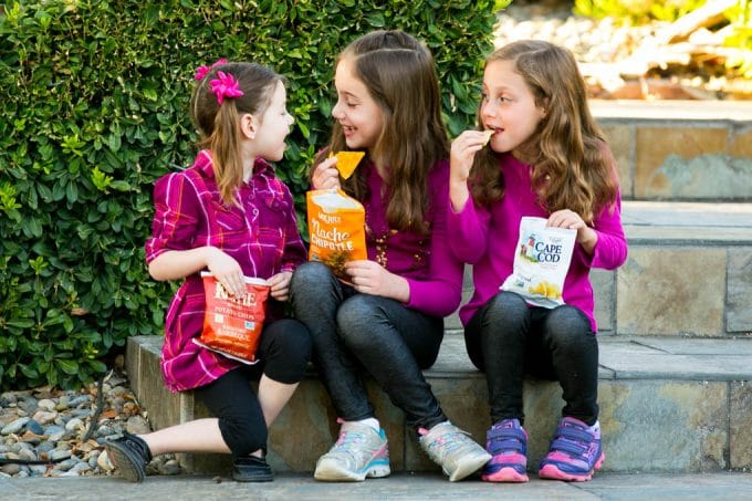 Kids eating bags of chips.