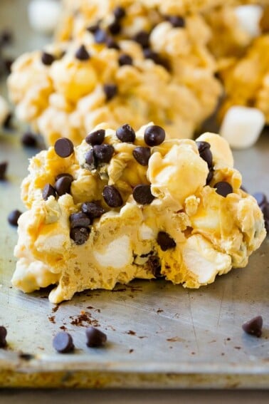 A close up of an avalanche cookie with a bite taken out of it.