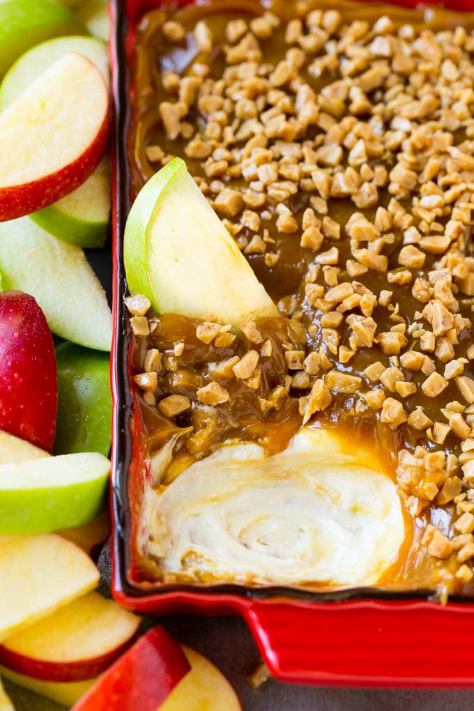 Caramel apple dip with an apple slice in it.