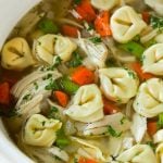 A slow cooker full of chicken tortellini soup.