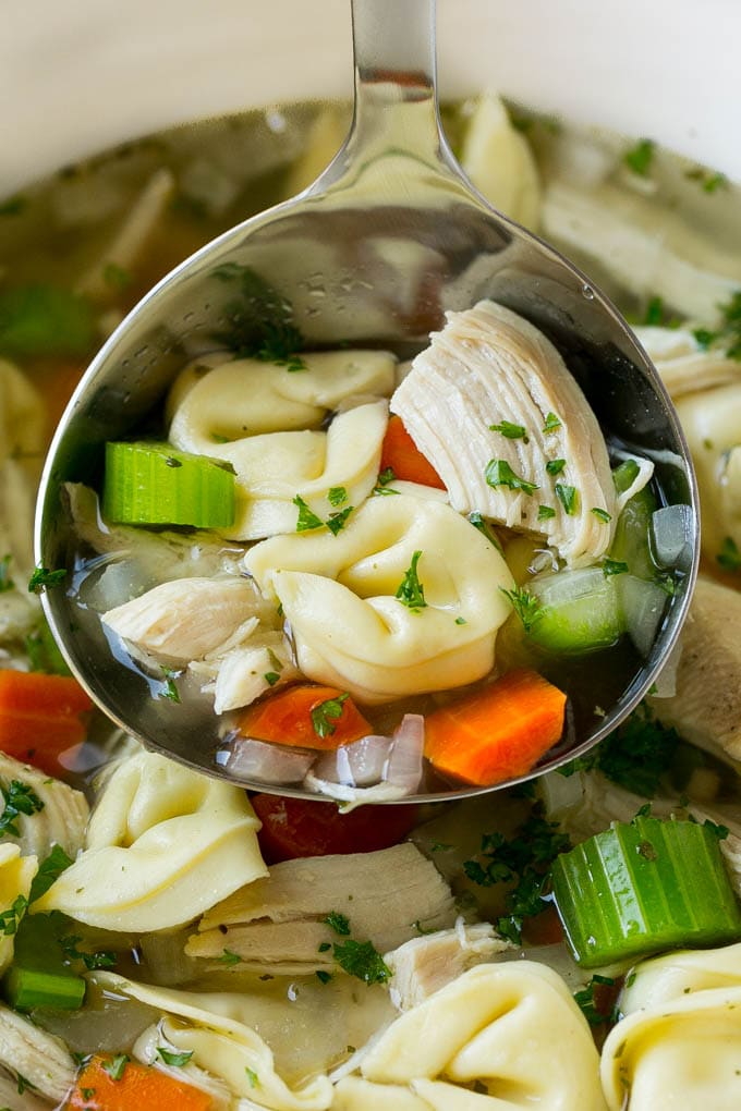 A ladle full of chicken tortellini soup.