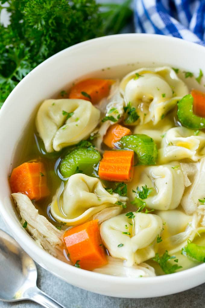 A bowl full of slow cooker chicken tortellini soup.