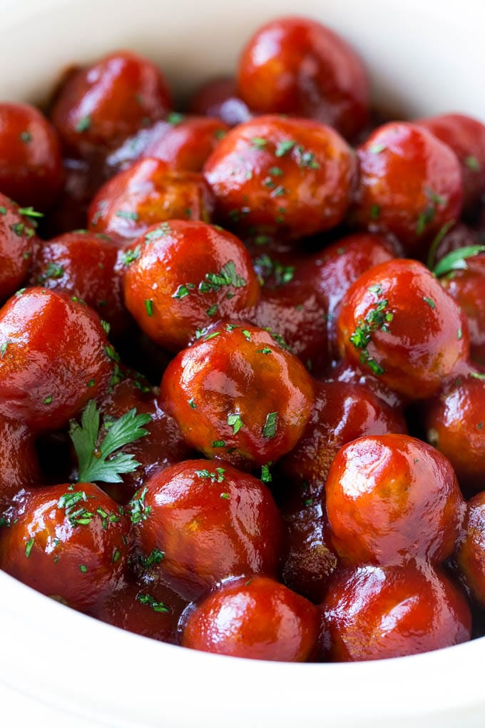 A crock pot full of cranberry meatballs.