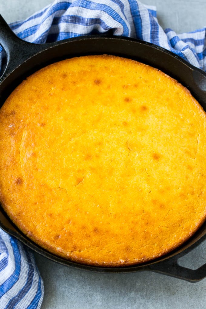 A cast iron pan of honey cornbread.
