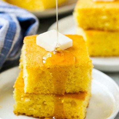 A stack of cornbread topped with butter and honey