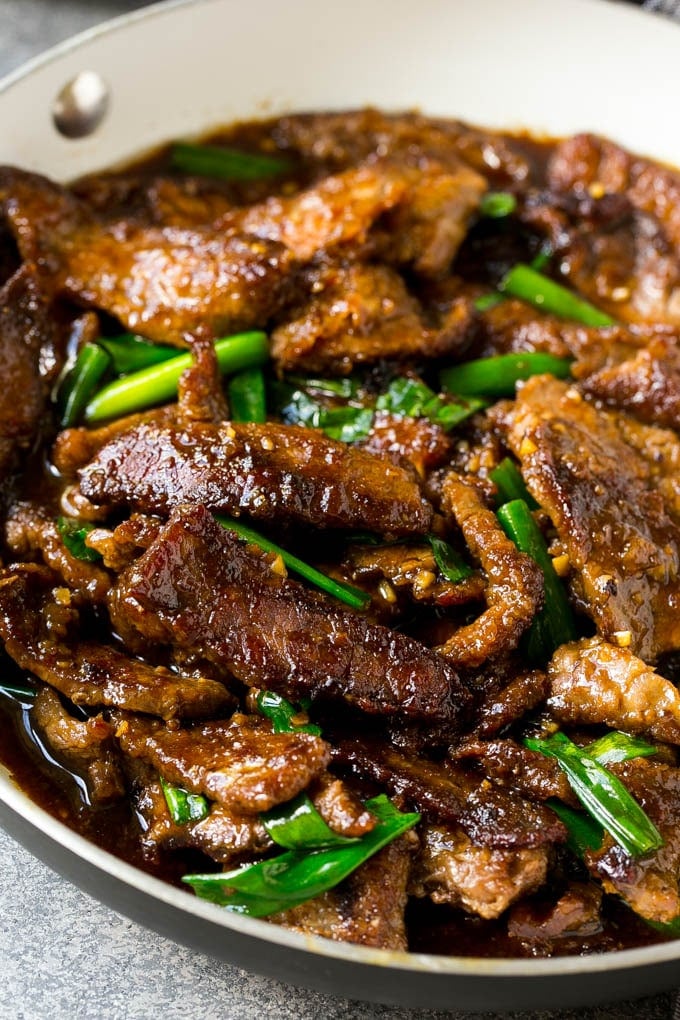 A pan full of Mongolian beef with green onions.