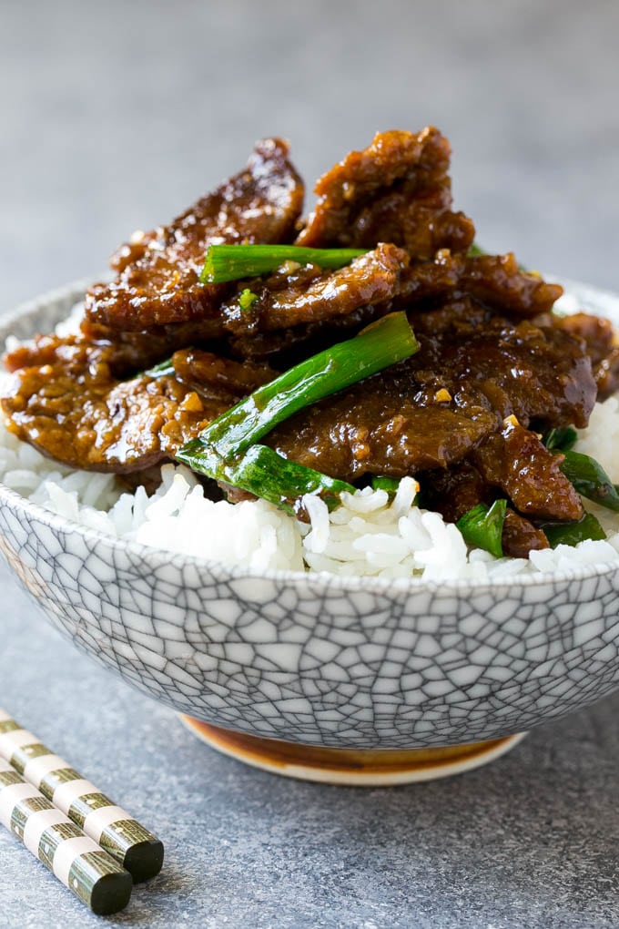 A bowl of mongolian beef over rice.