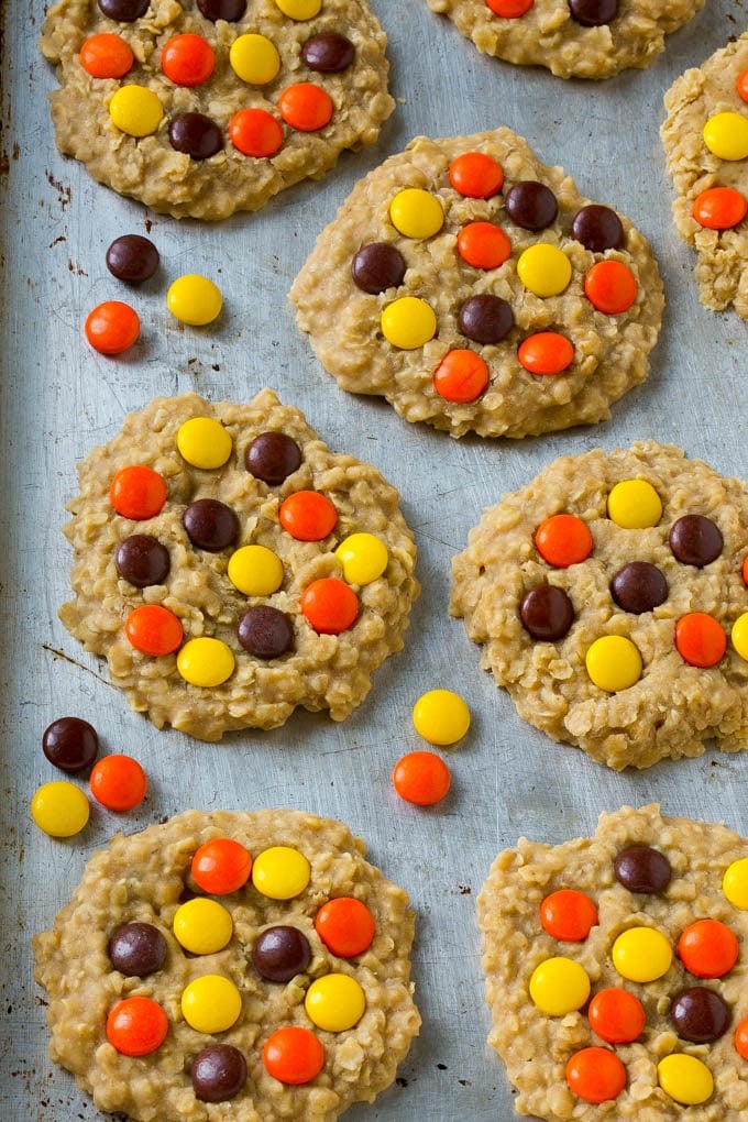 A sheet pan full of cookies with candies on top.