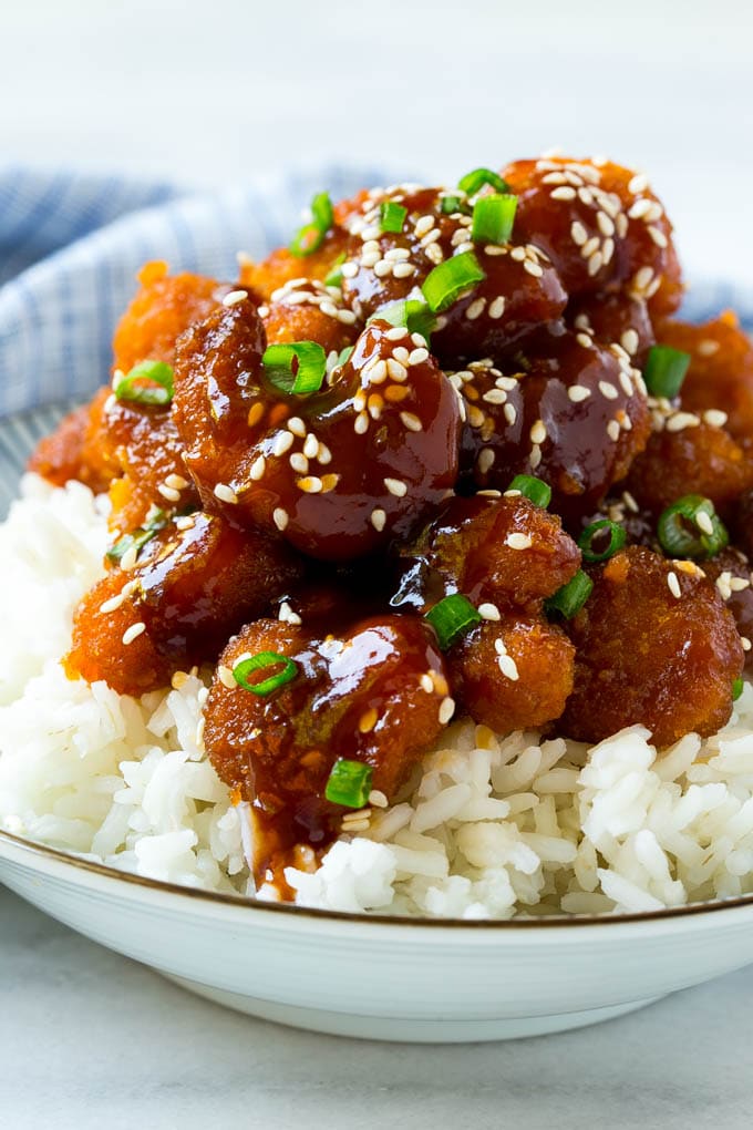 A bowl of Asian style crispy sesame shrimp over rice.