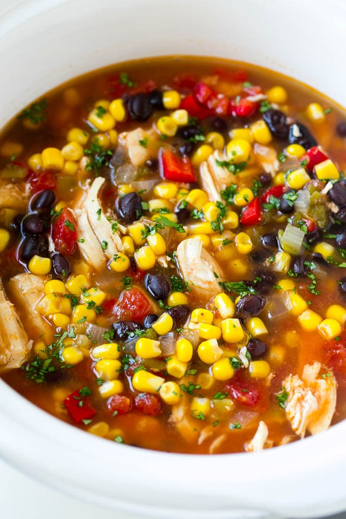 A slow cooker full of chicken tortilla soup.