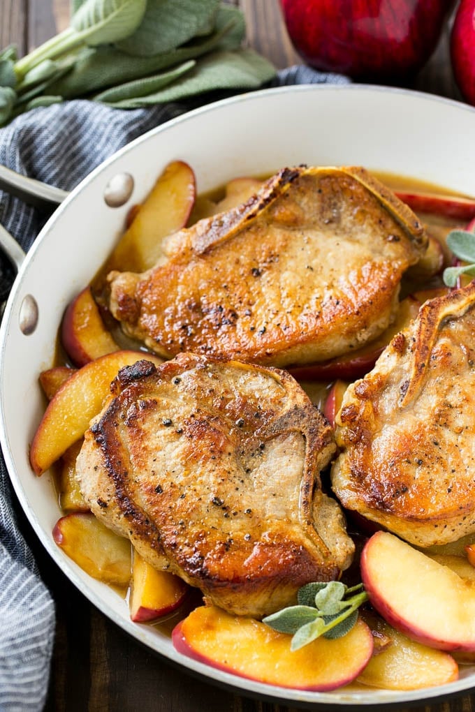 A pan of apple pork chops with sage.