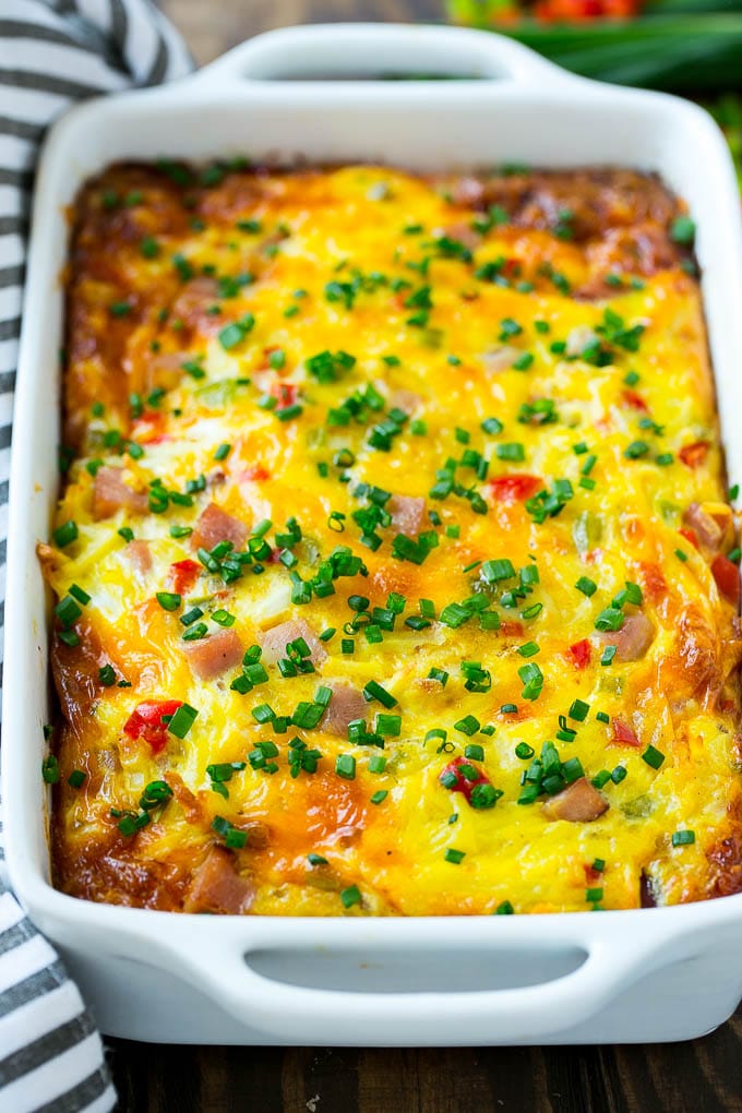 Hash brown casserole with ham, vegetables and cheese in a baking dish,