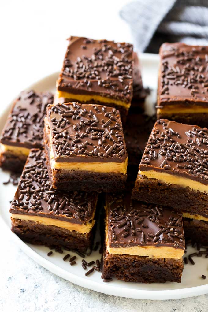 Peanut butter brownies with a chocolate brownie base, peanut butter frosting and fudge topping.
