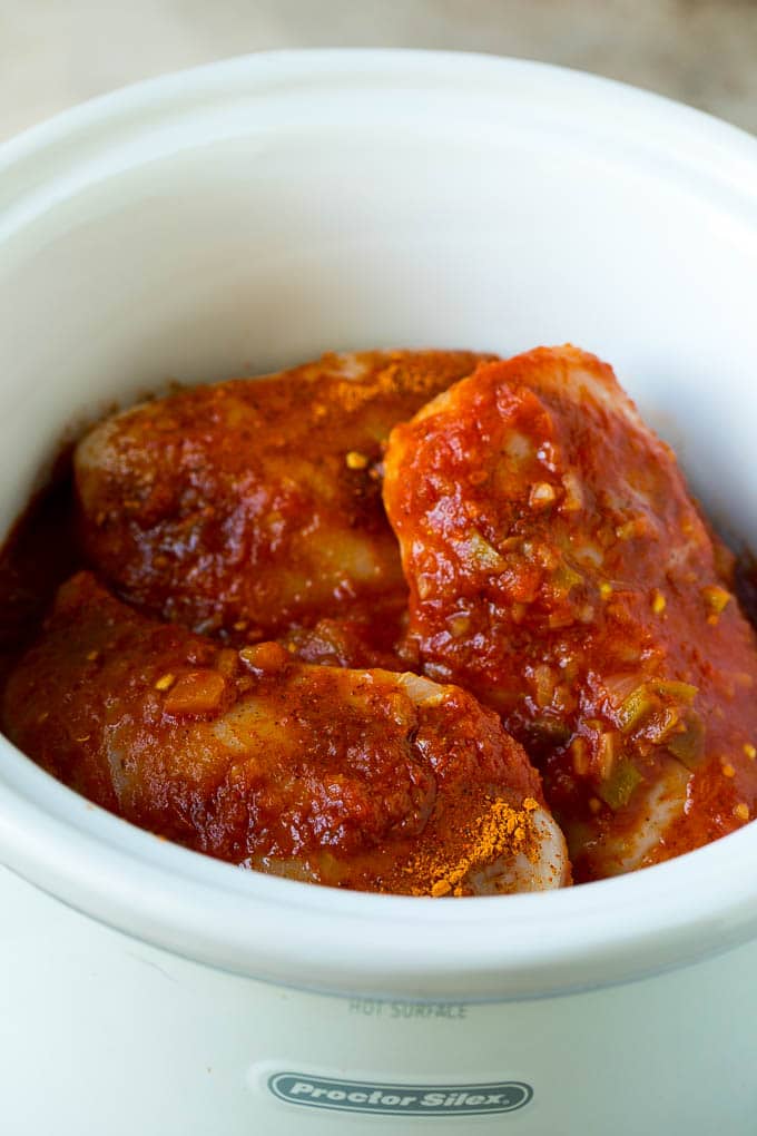 Chicken breasts topped with taco seasoning and salsa.