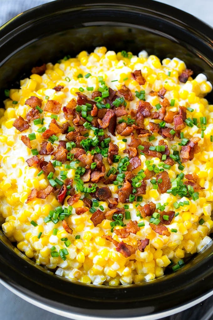 Slow Cooker Creamed Corn topped with bacon and chives.