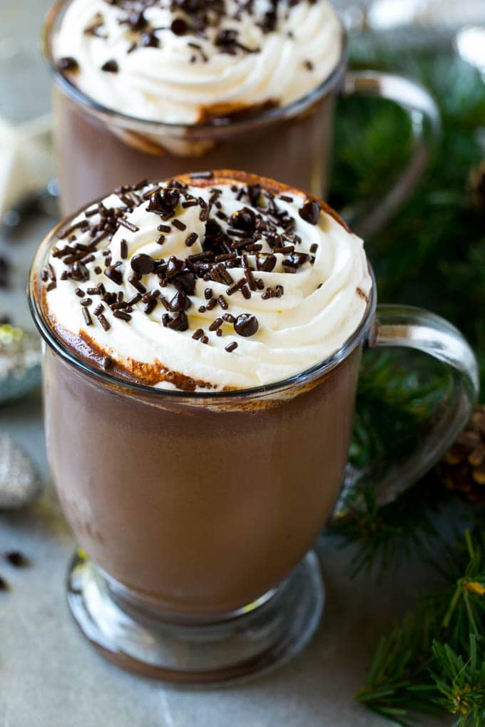 A mug of crock pot hot cocoa topped with whipped cream.