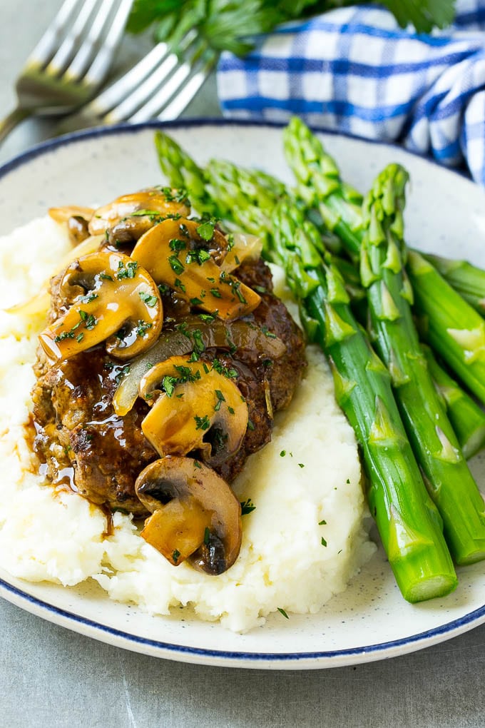 Slow cooker salisbury steak with mushroom gravy over mashed potatoes.