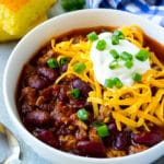 A bowl of slow cooker turkey chili topped with sour cream and cheese.
