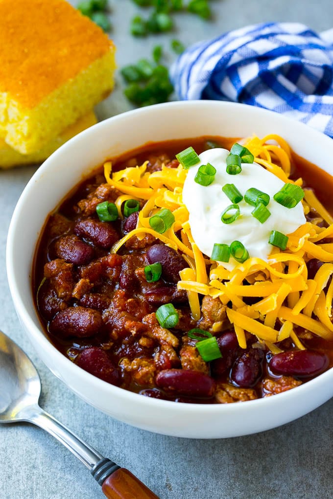 A bowl of slow cooker turkey chili topped with sour cream and cheese.