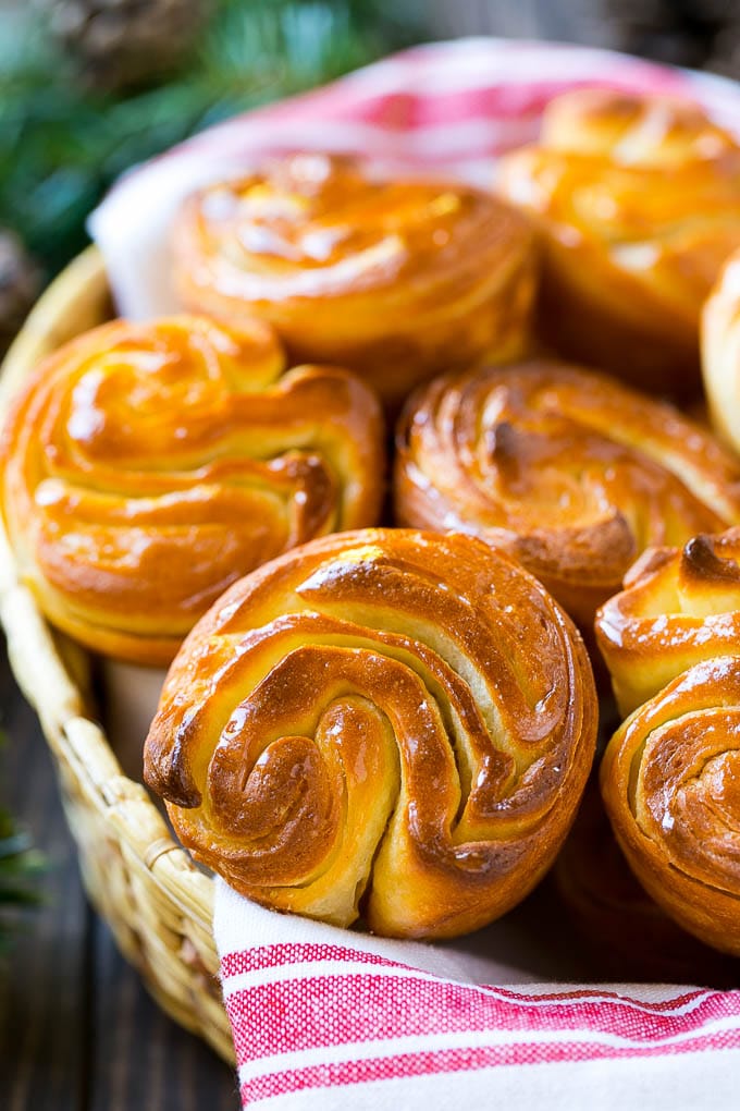 A close up of butterflake rolls in a woven basket.