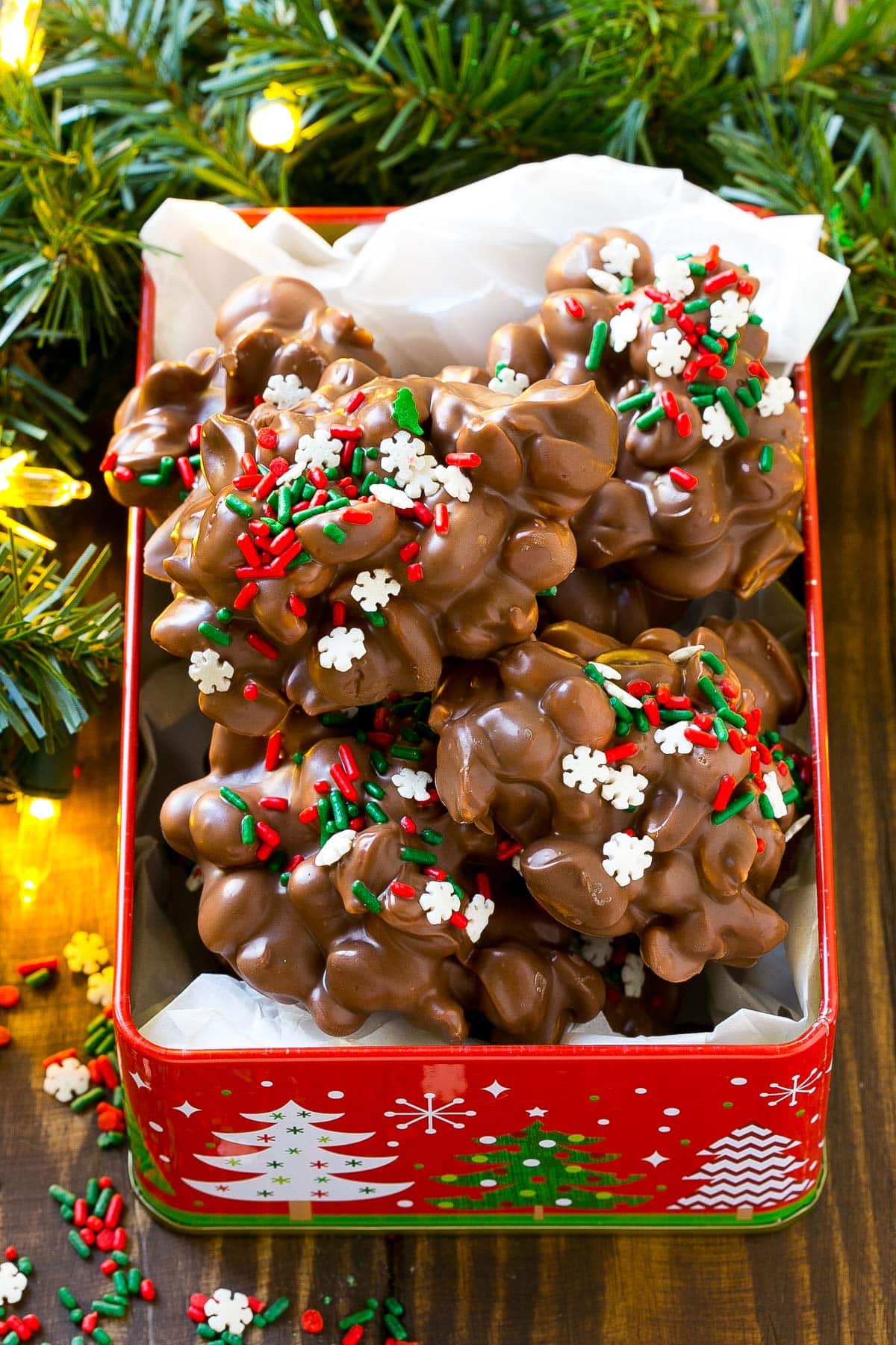 Crock pot candy peanut clusters in a decorative tin.