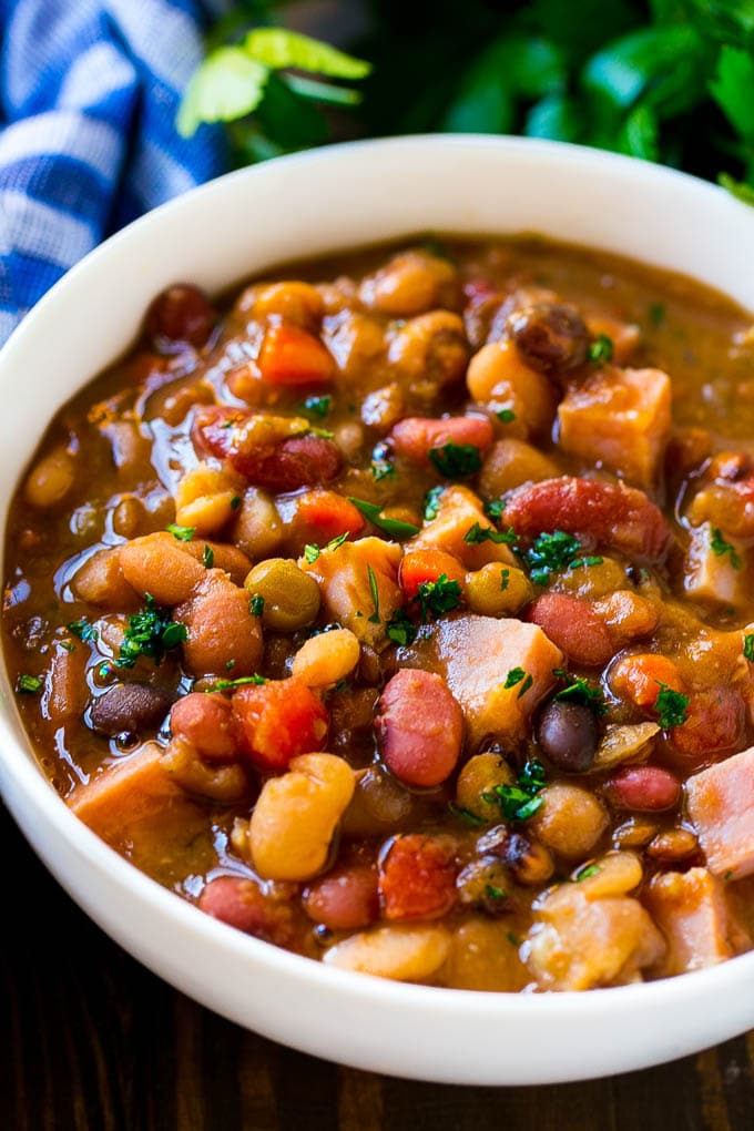 A bowl of ham bone soup with beans and vegetables.